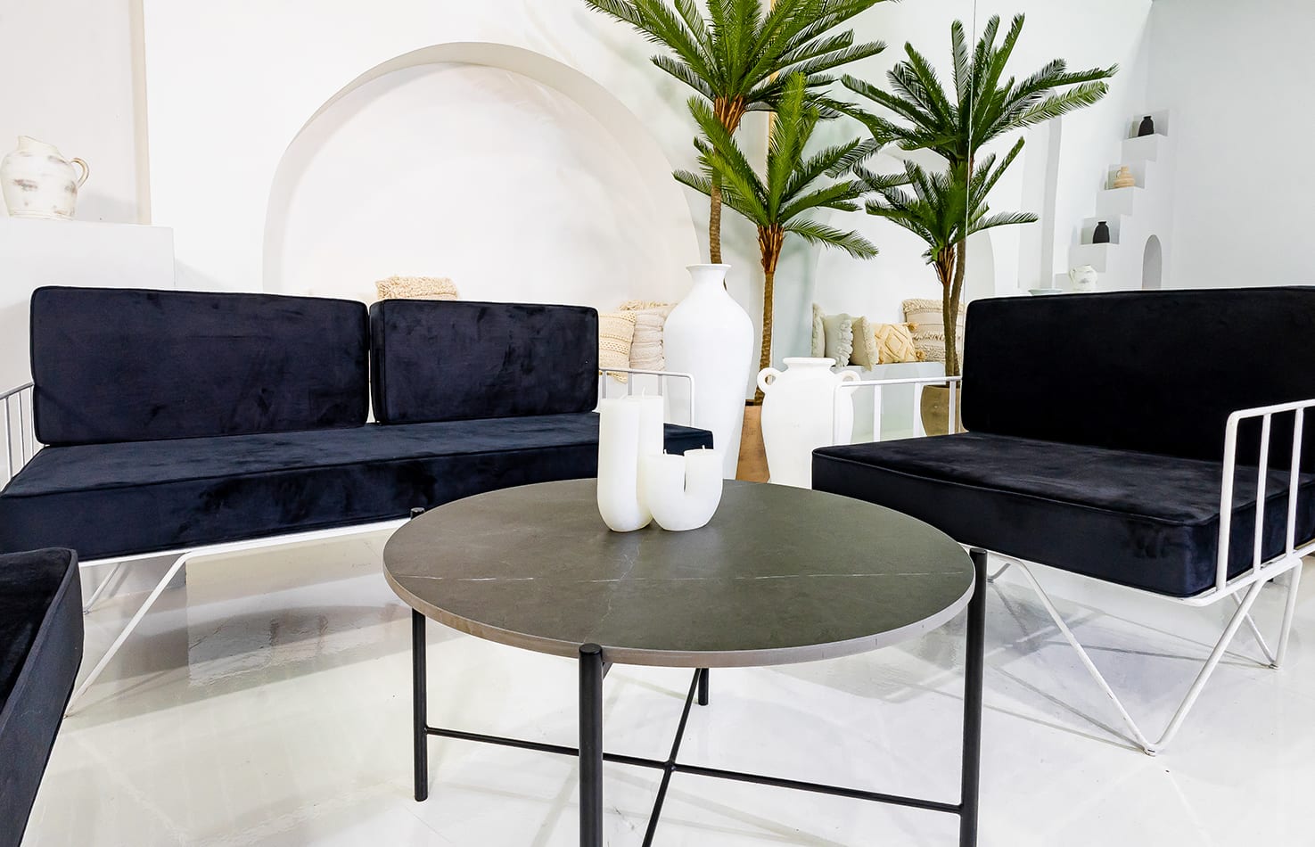 Black Cross Coffee Table next to velvet blue lounges