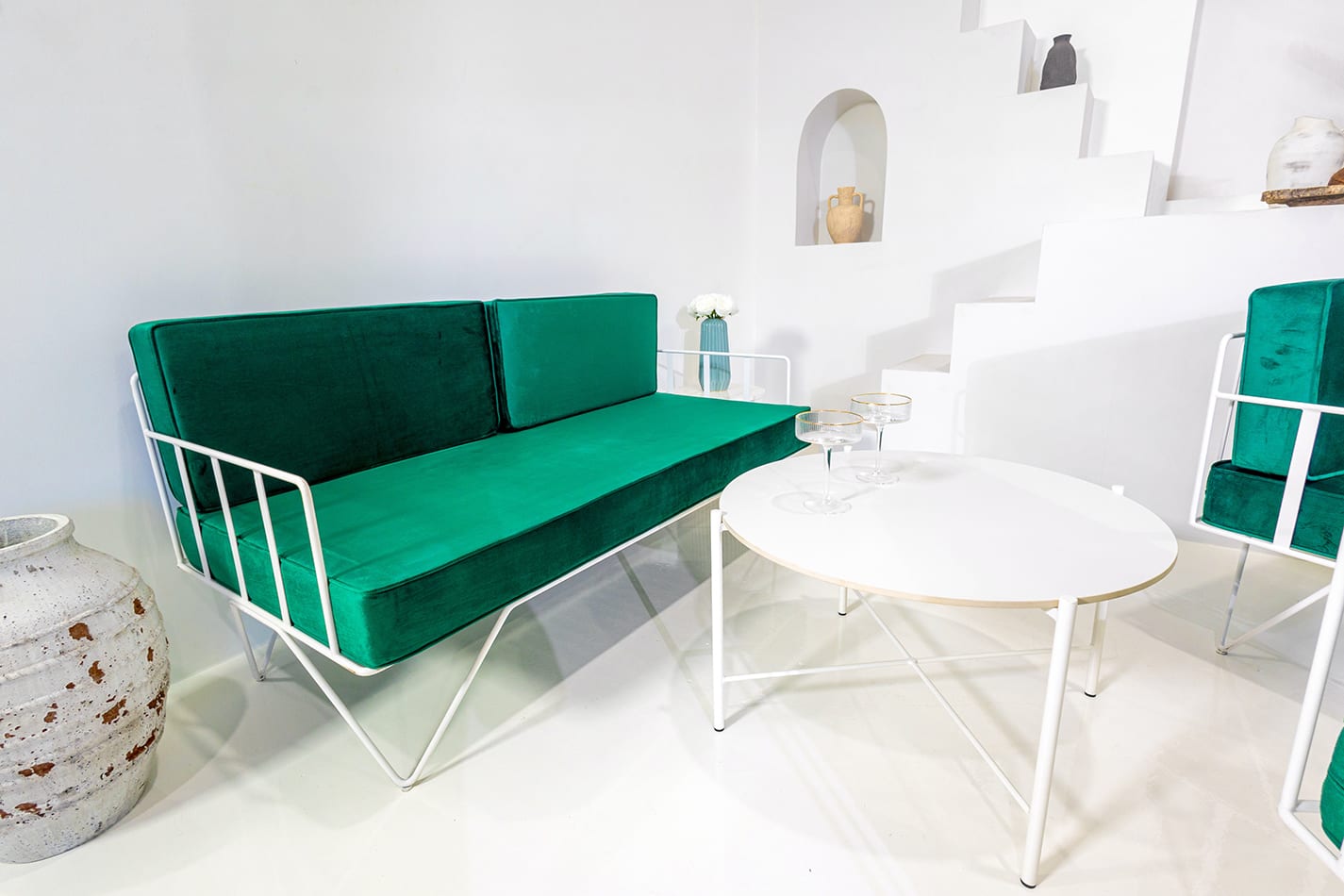 White Cross Coffee Table nest to an Emerald velvet lounge