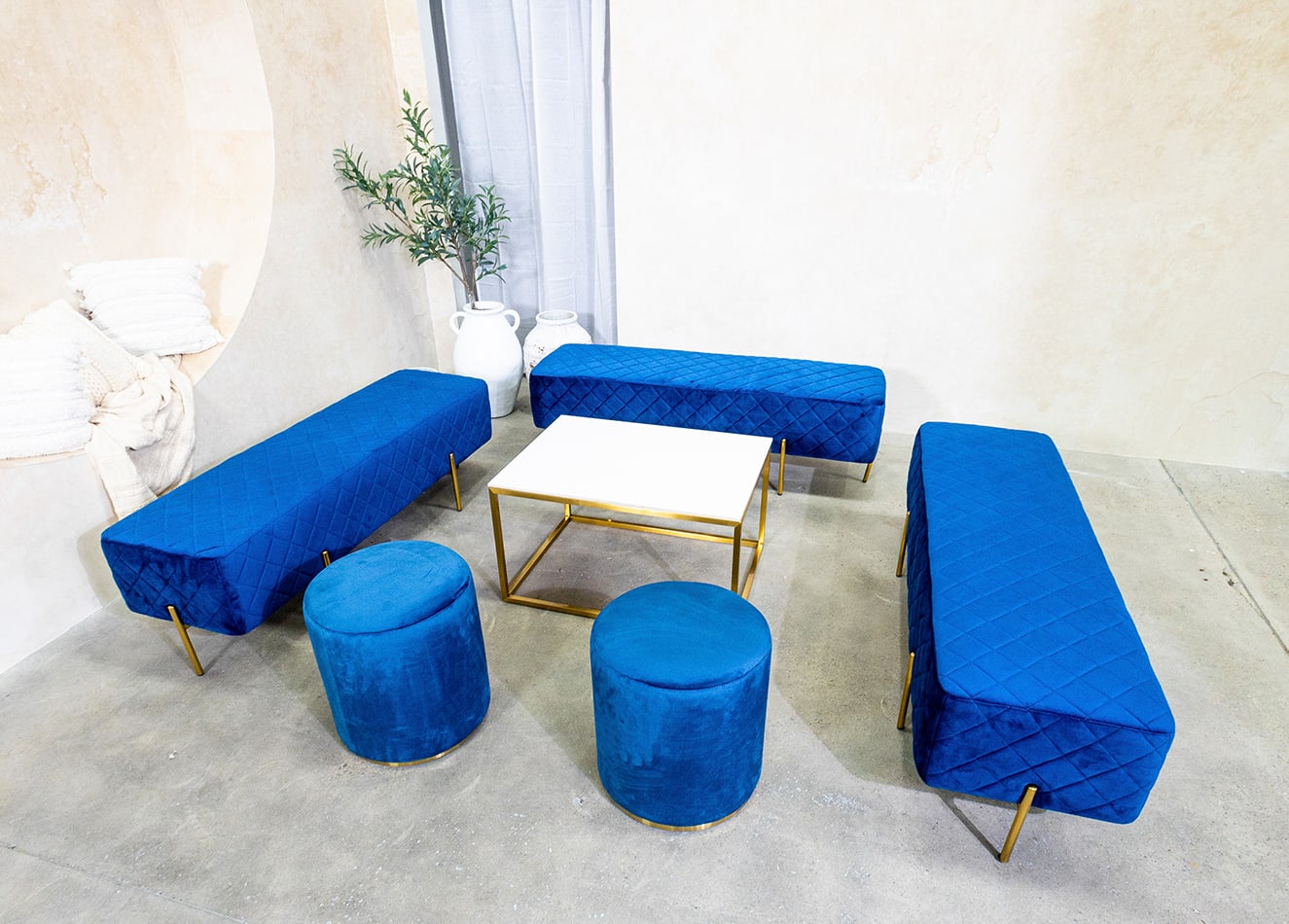 Navy blue ottoman stools next to an ottoman lounge