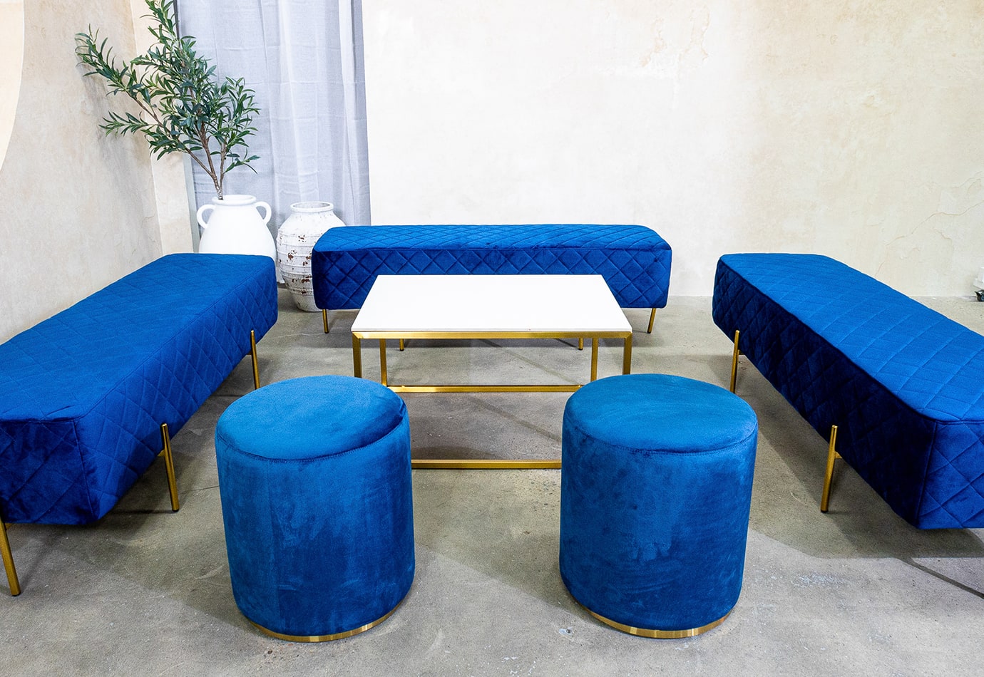 Two velvet navy blue ottoman stools