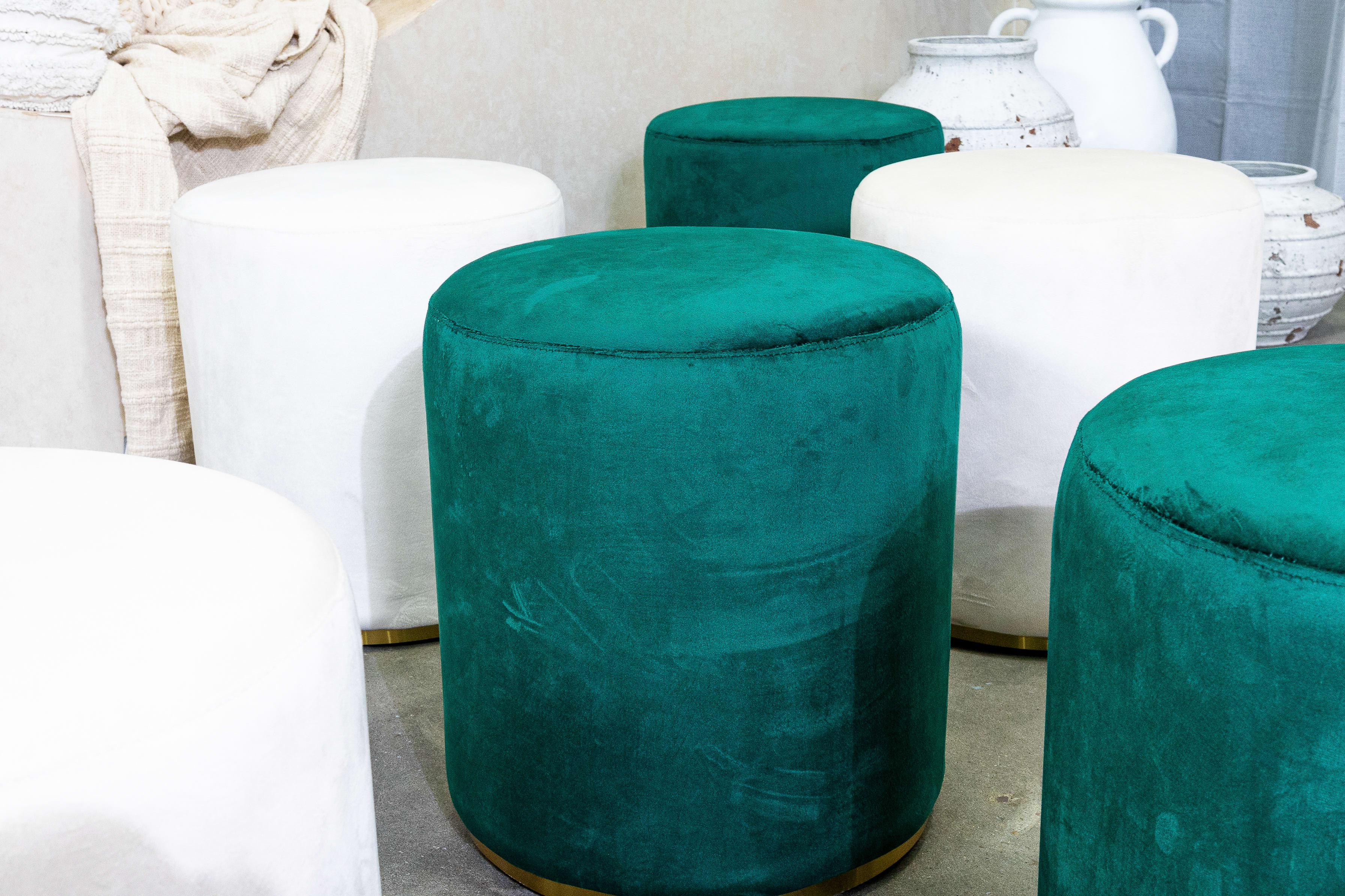 Close-up of the green velvet ottoman stool