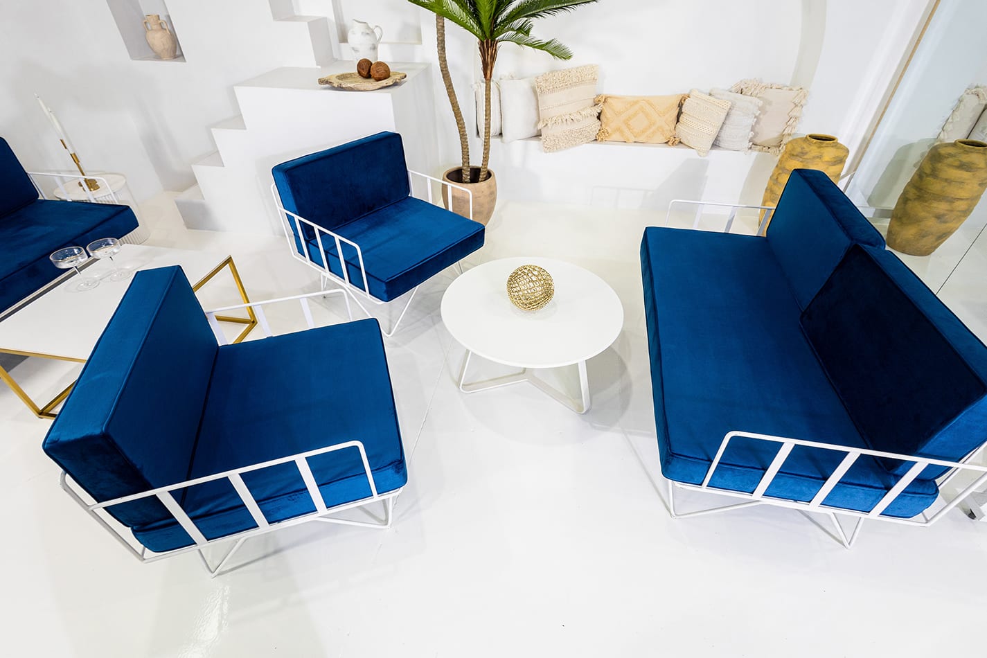 Our white wire lounge chair set with blue velvet cushions