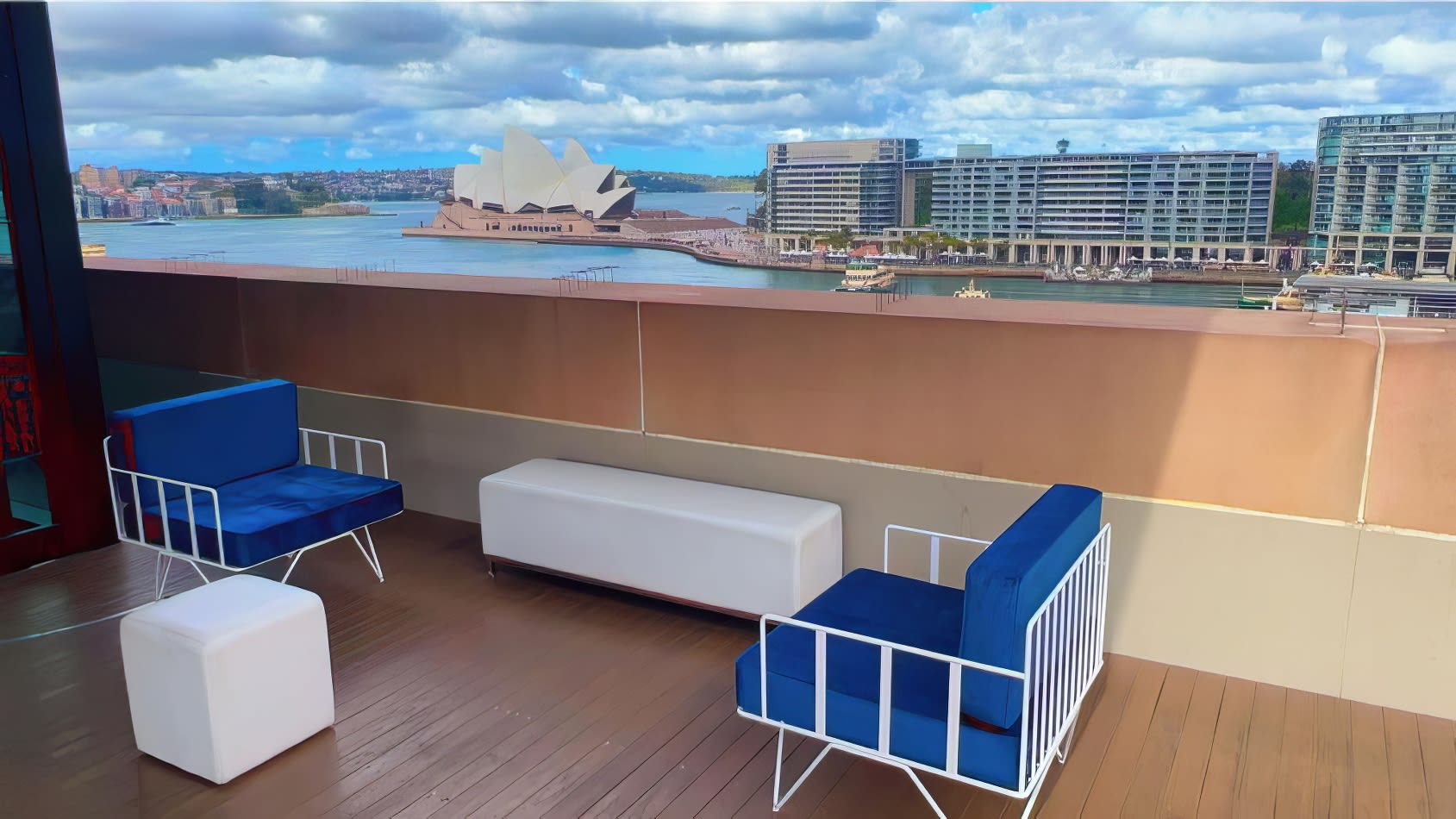 White wire lounge chairs with Sydney Harbour in the background