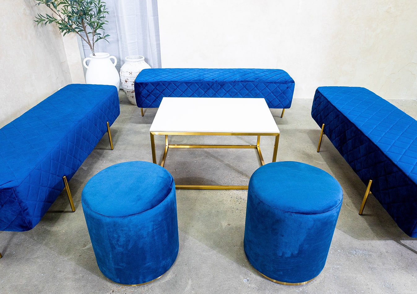 Ottoman benches with navy blue velvet cushions