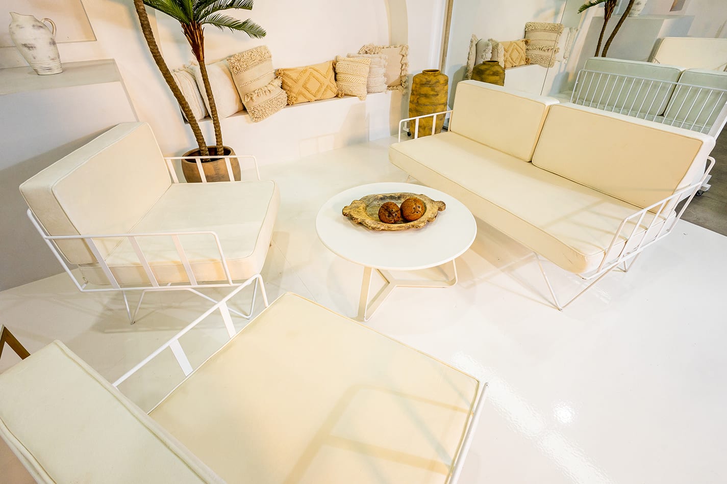 White velvet cushions on a wire sofa lounge