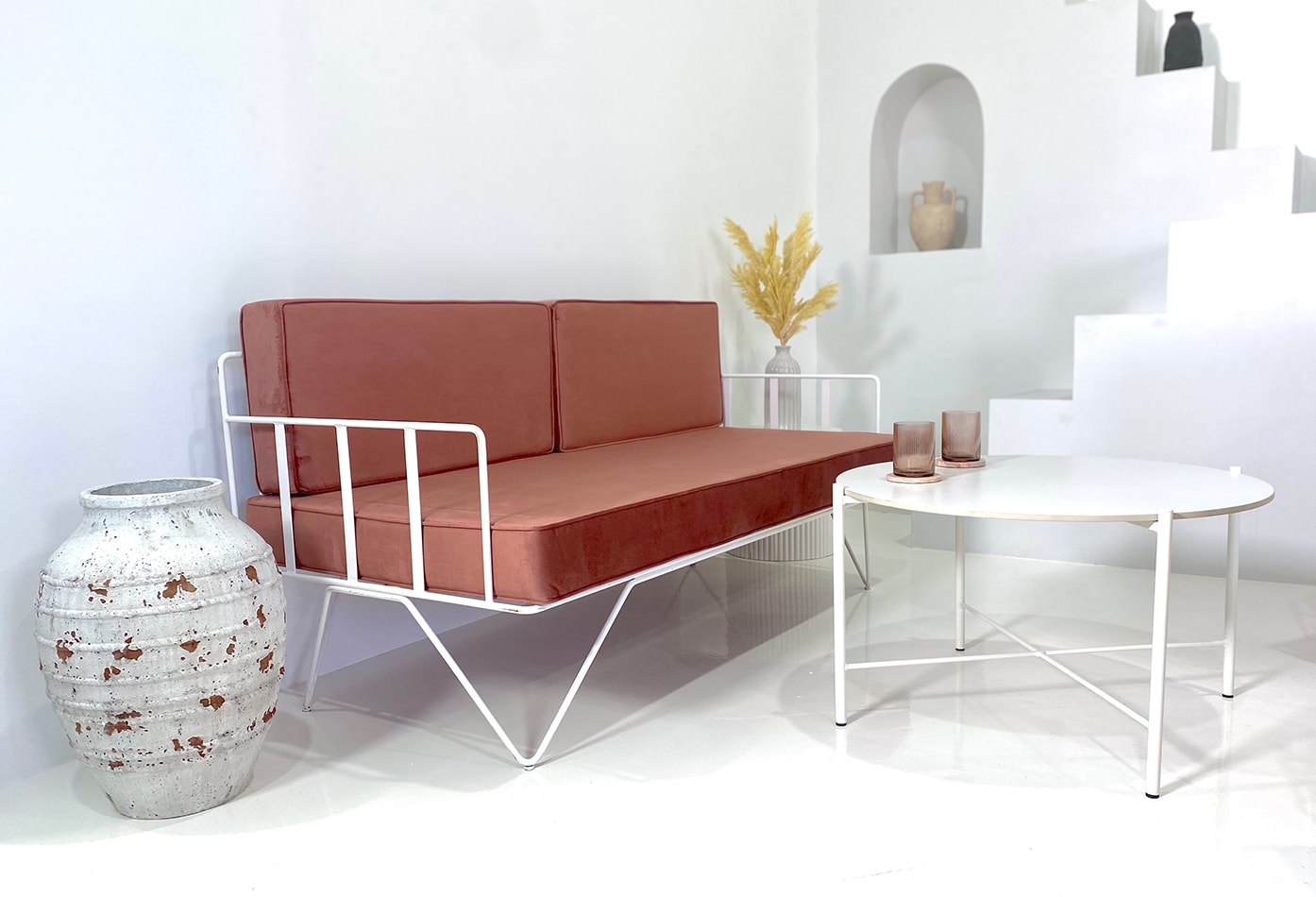 White wire sofa lounge with pink velvet cushions