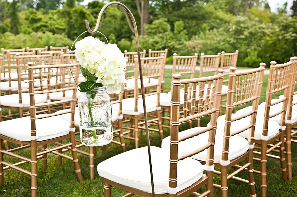 Gold Tiffany chairs with white cushions