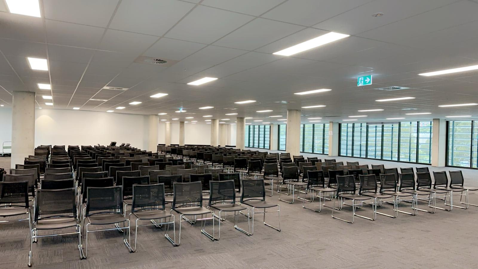 Conference chairs hired for a large indoor corporate meeting