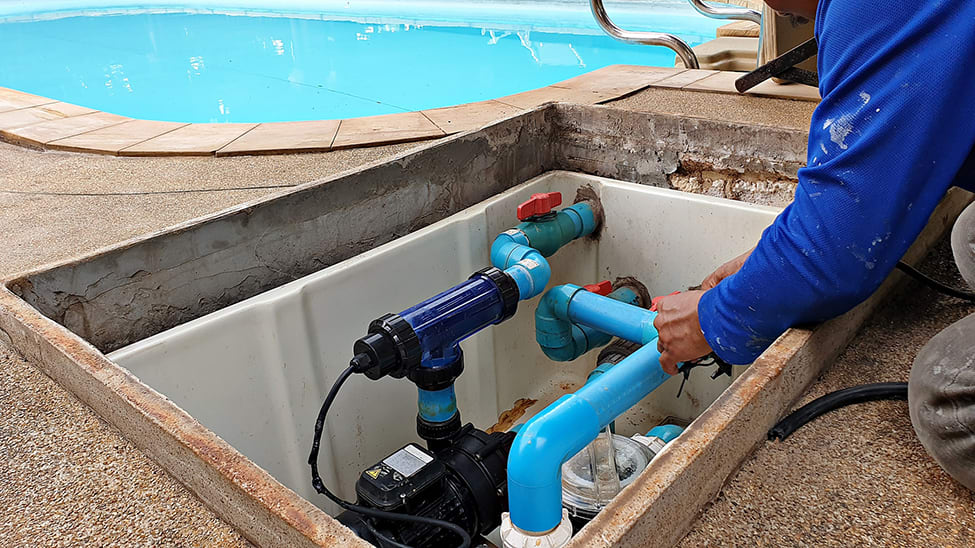 An electrician servicing a pool pump