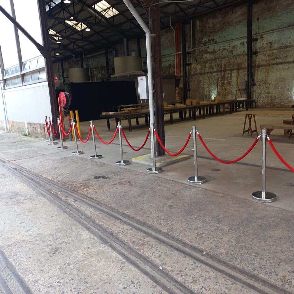 Red velvet rope on chrome bollards