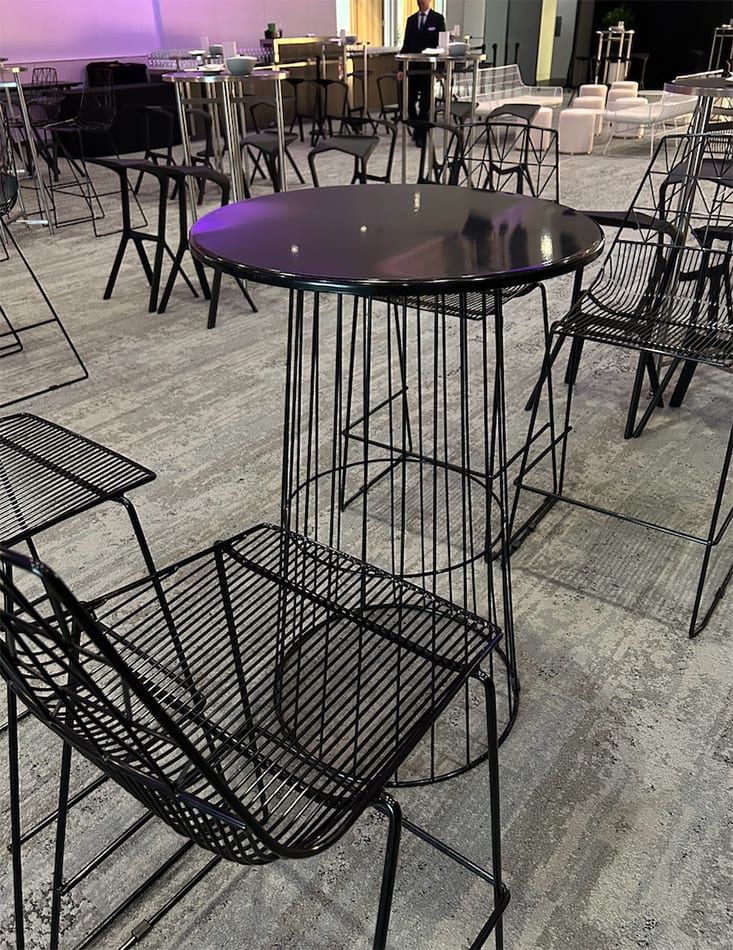 Black wire cocktail tables set up for a function