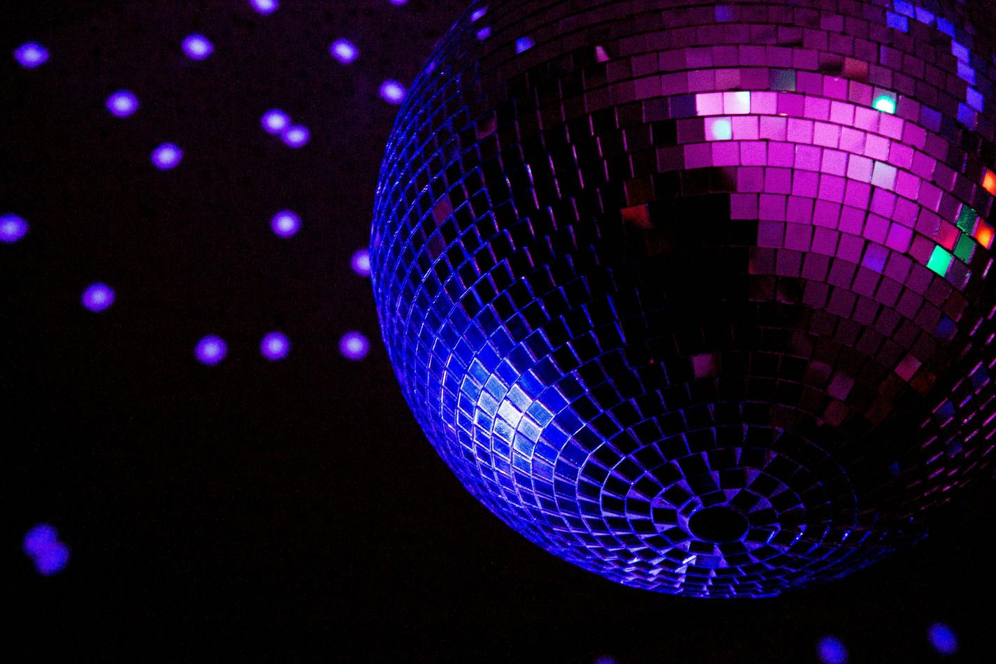 A disco ball in action with purple lights