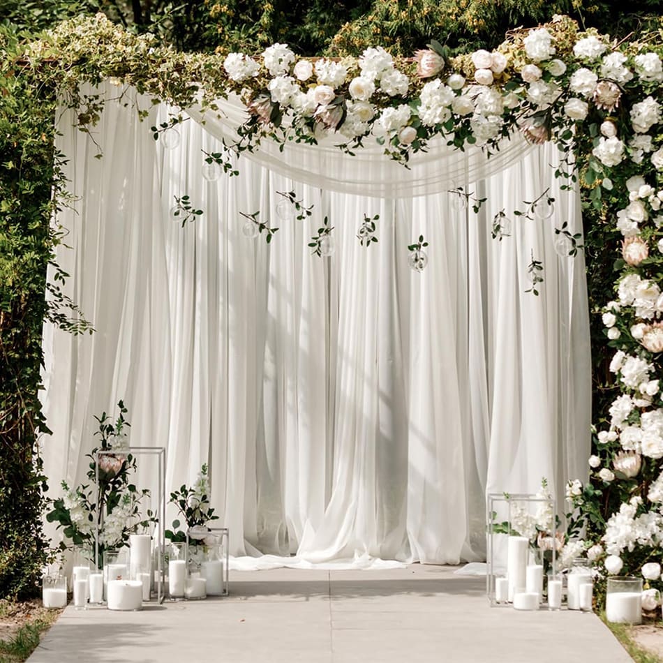 Our silk white drapes being used as a backdrop at a wedding reception