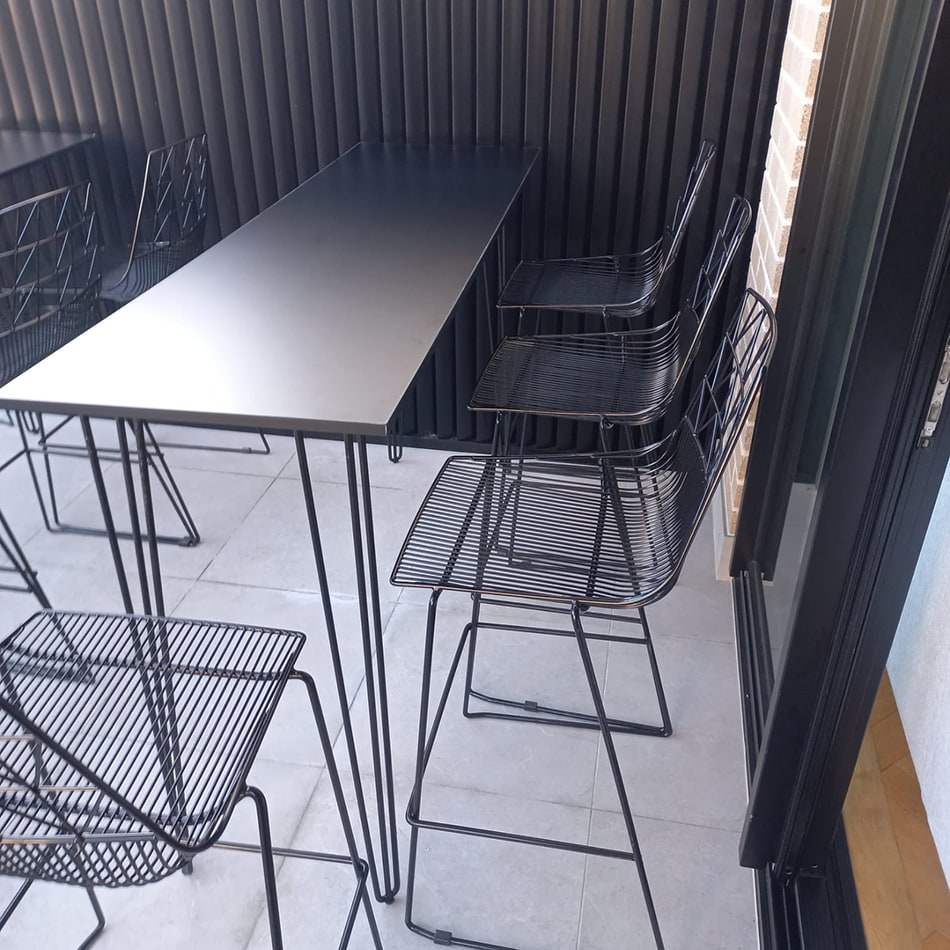 Black hairpin table set up with chairs