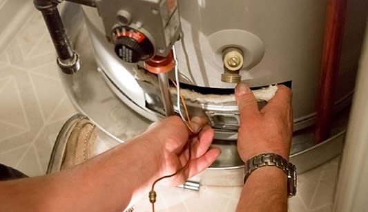 An electric hot water system being repaired