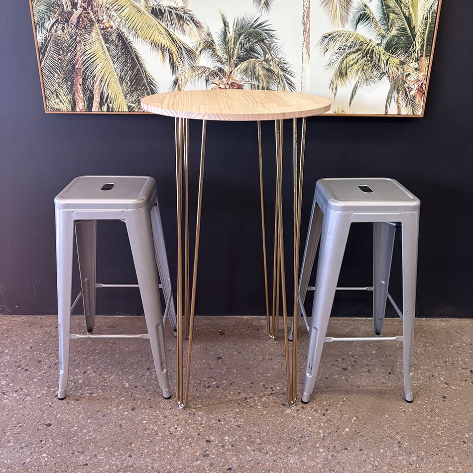 Our gold hairpin round cocktail table being used with stools