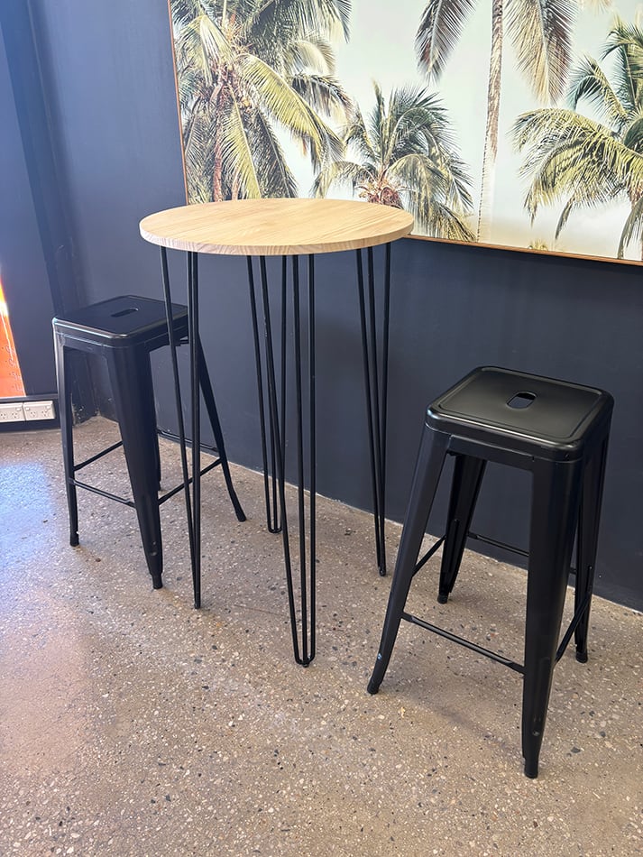 Our black hairpin round cocktail table with some tolix tools