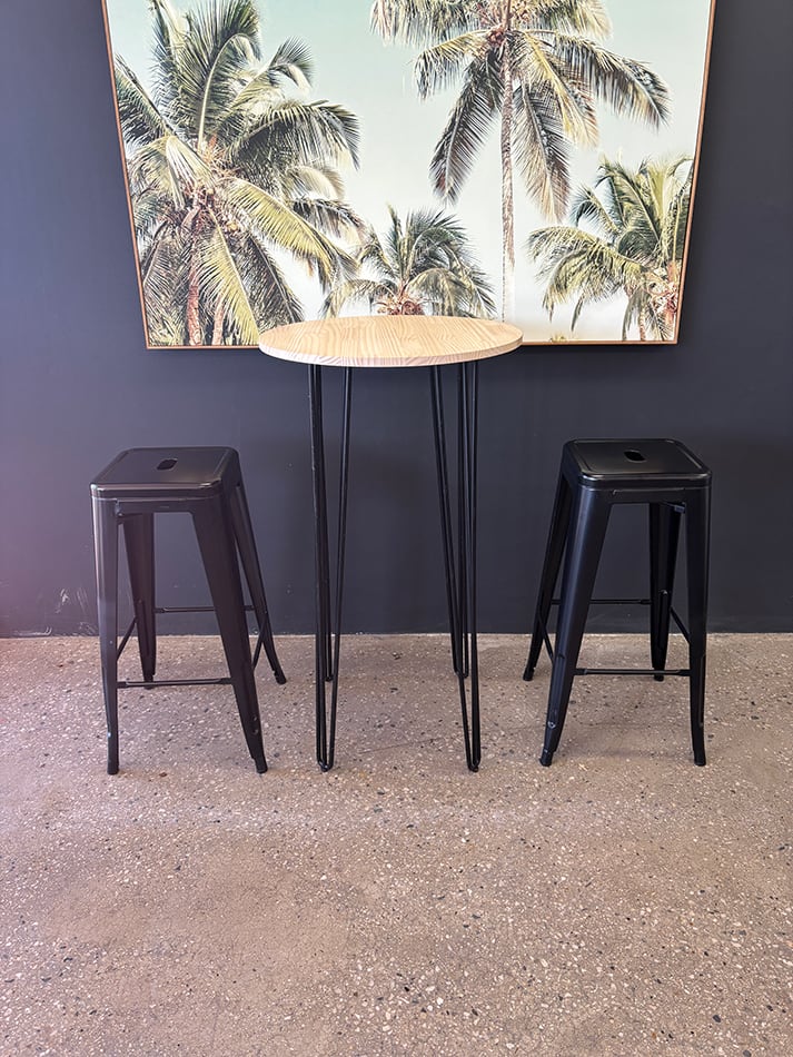 Our round cocktail table underneath a painting
