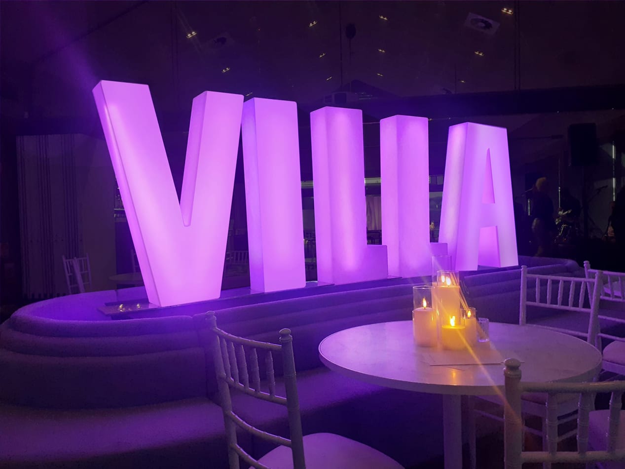 Large purple glow letters spelling the word villa
