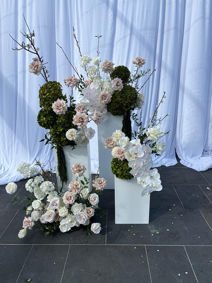 White plinths used for flower decorations