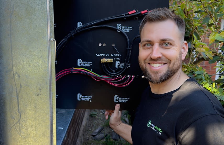 An electrician performing a switchboard upgrade in Sydney