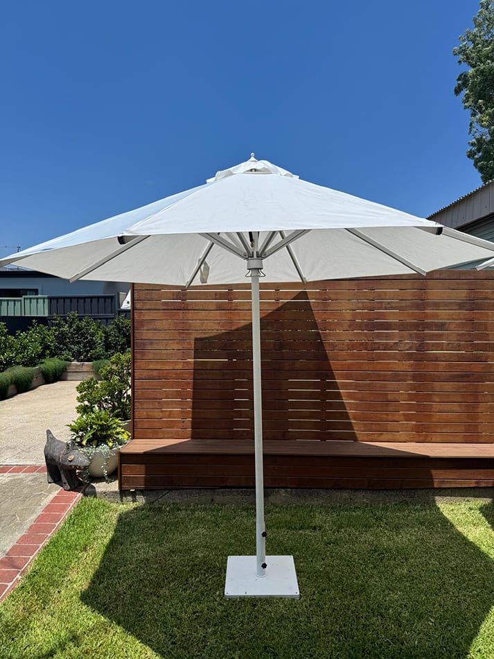 Our market umbrella near an outdoor lounge area