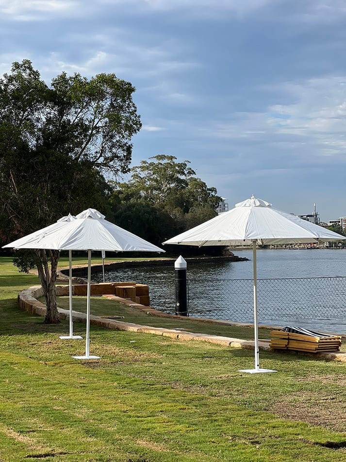 Our market umbrellas on a lake edge