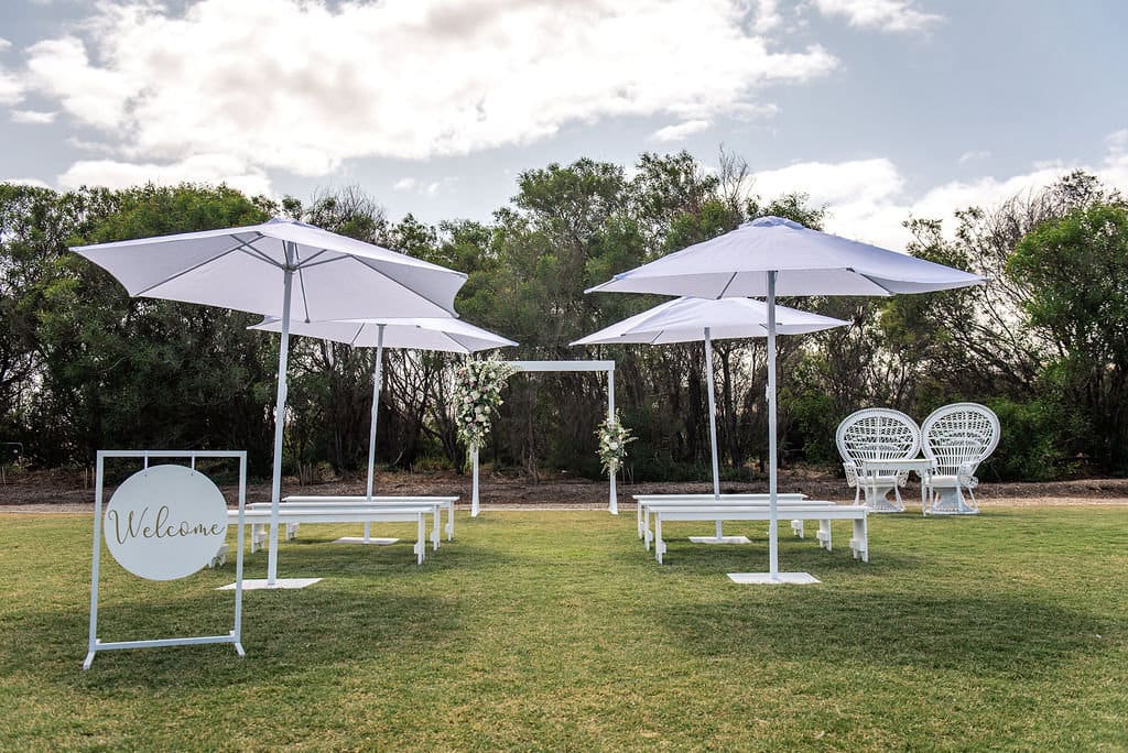 Strategically placed umbrellas at an outdoor wedding