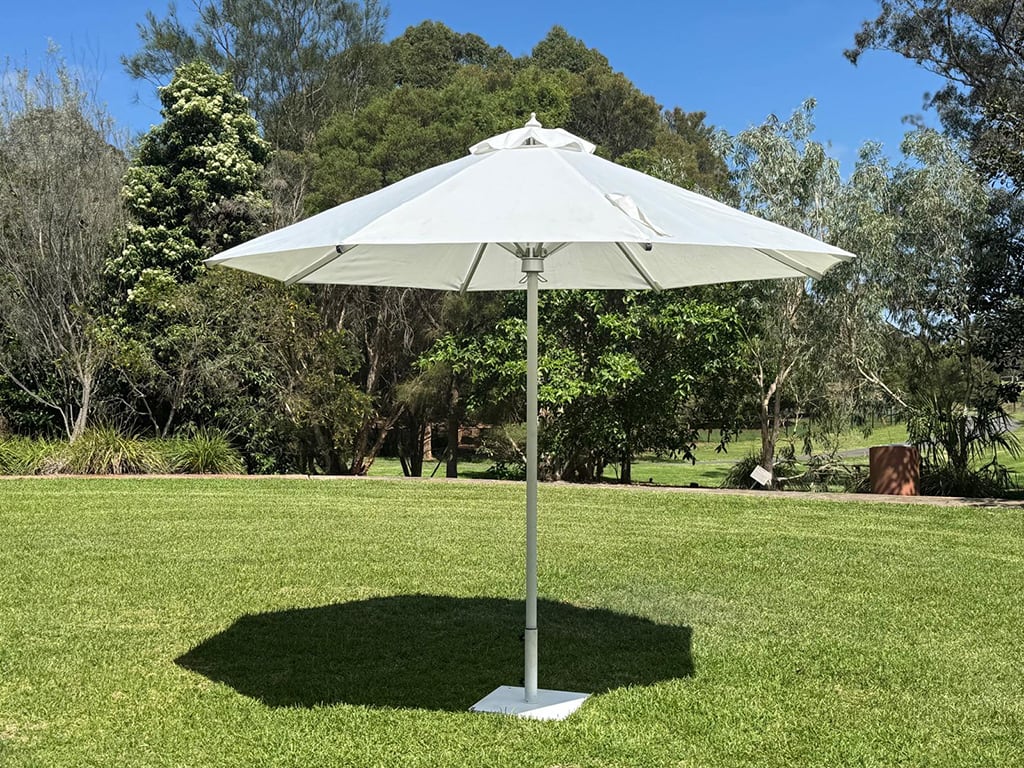 A hired outdoor umbrella at a park