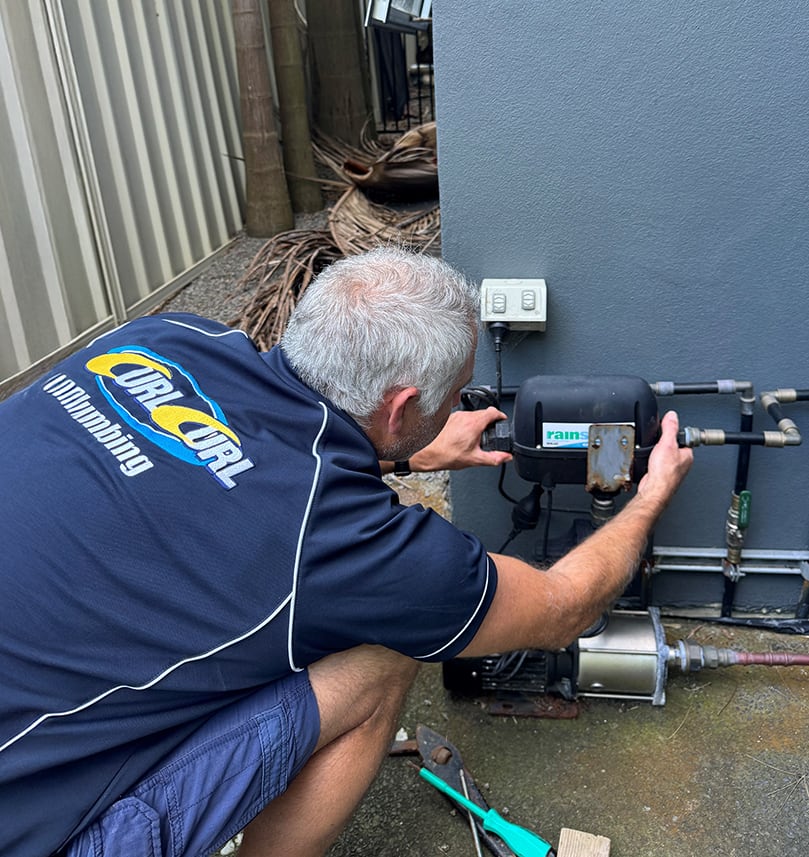 A Sydney plumber repairing a rainwater tank plumbing system