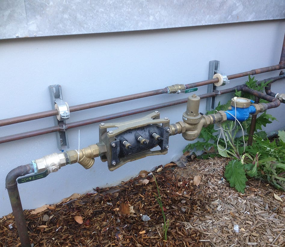 A new water backflow prevention device installed on a residential property