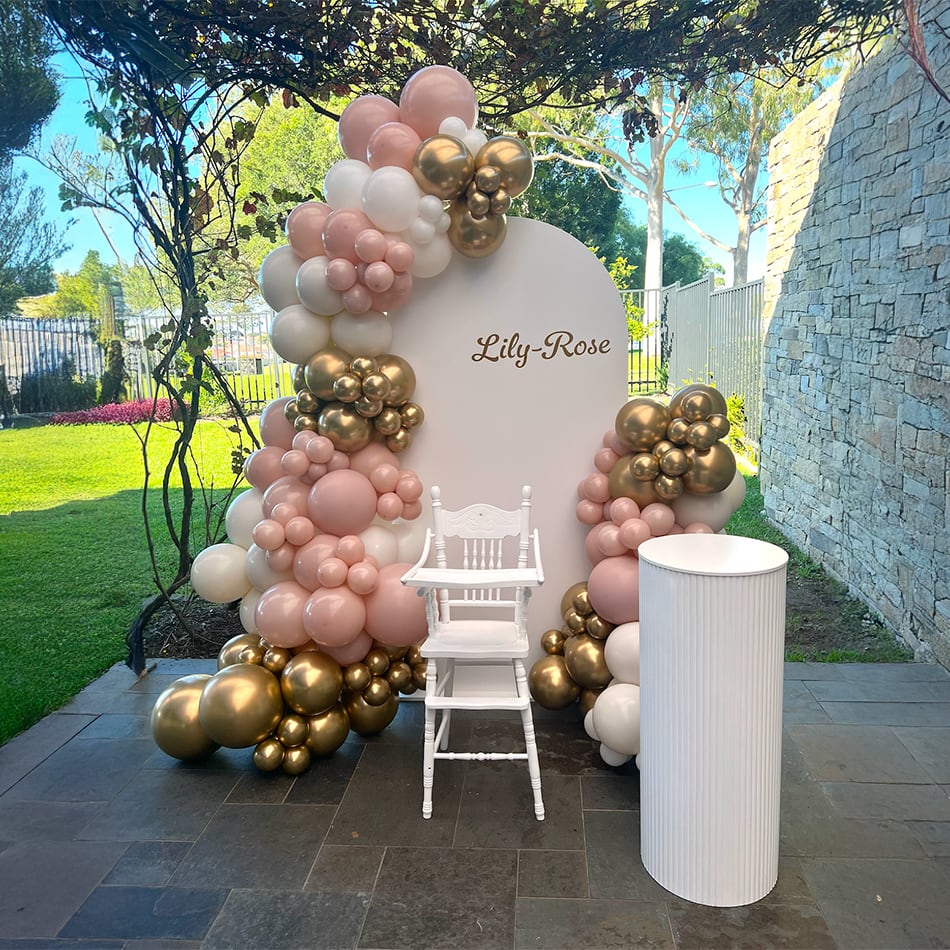 A pink and gold balloon package for a christening