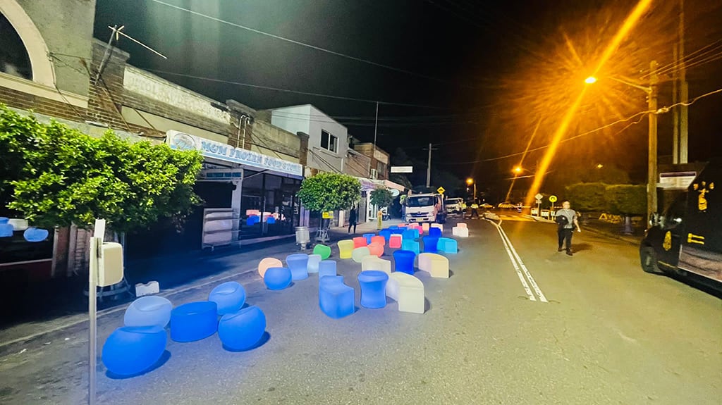 Glow seats and glow tables on a street at night