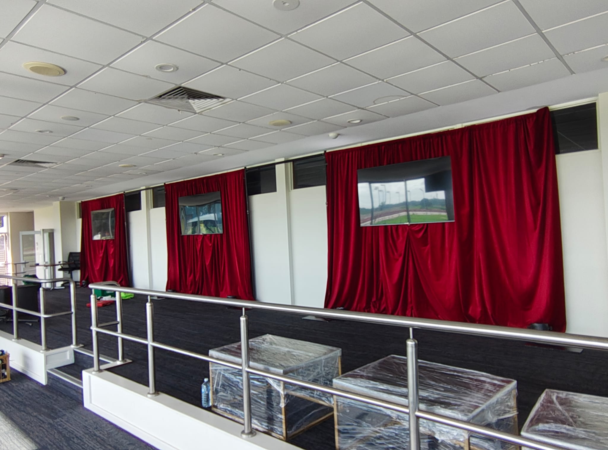 3 red velvet drapes hired for a stage event