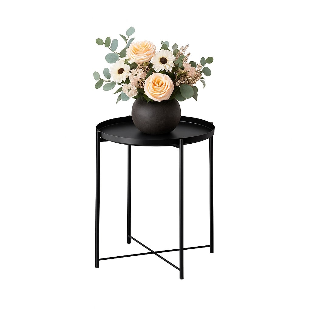 Black round side table with a vase of soft pastel flowers and greenery, photographed against a white background to showcase the product for hire.