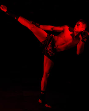 Fighter in kicking pose