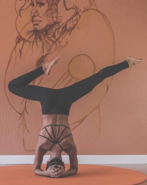 Girl on her head doing Yoga