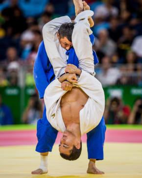 Guy executing a standing arm bar