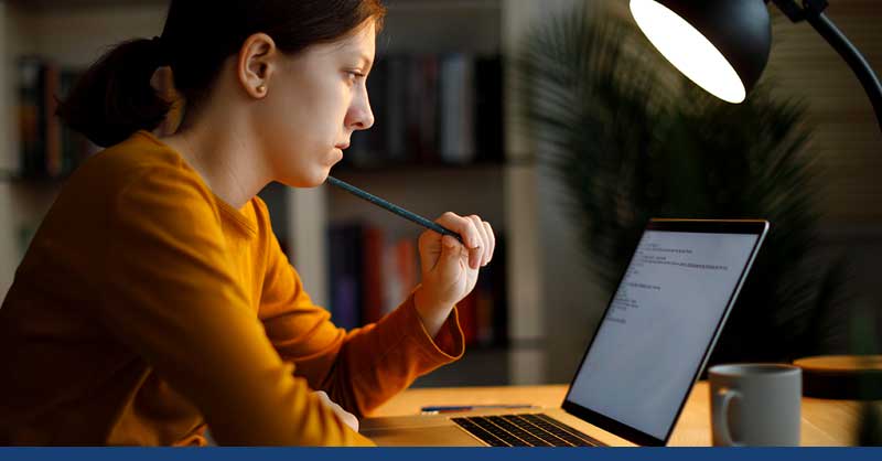 Woman sitting at desk working on laptop