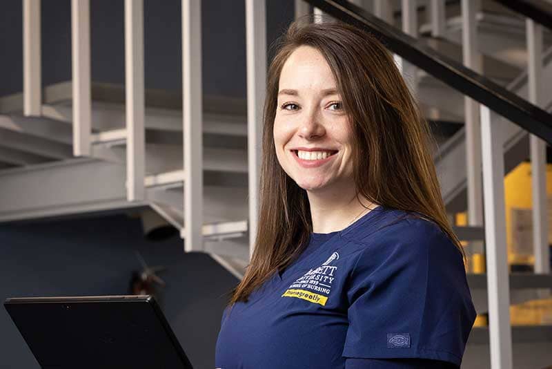 ABSN student smiling by stairs