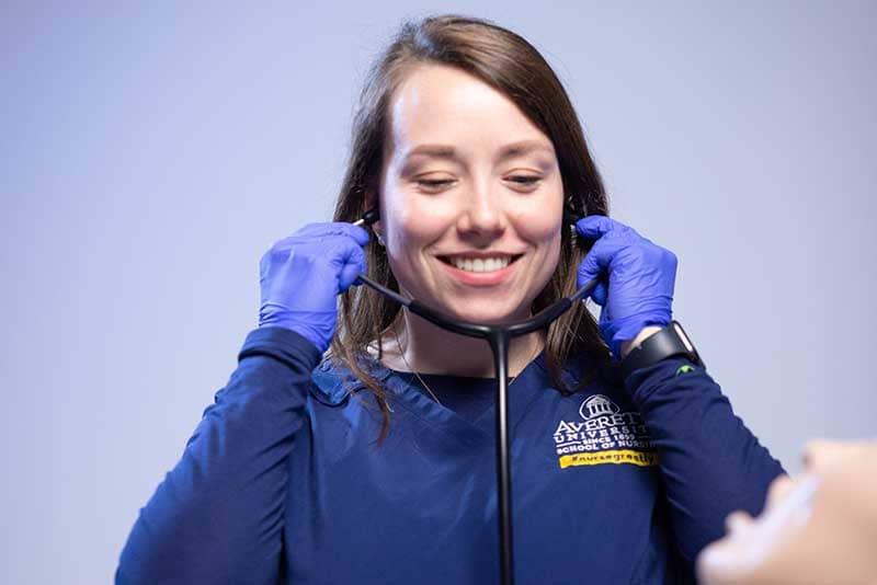 ABSN student using stethoscope