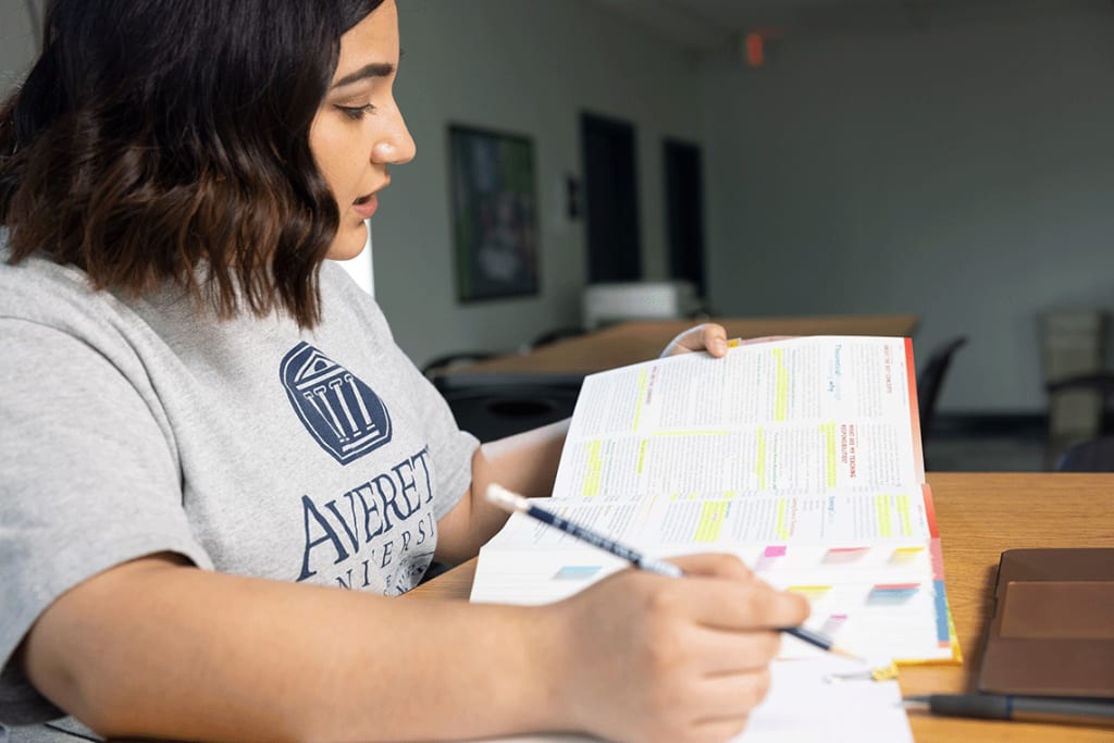 Averett ABSN student sitting at desk studying