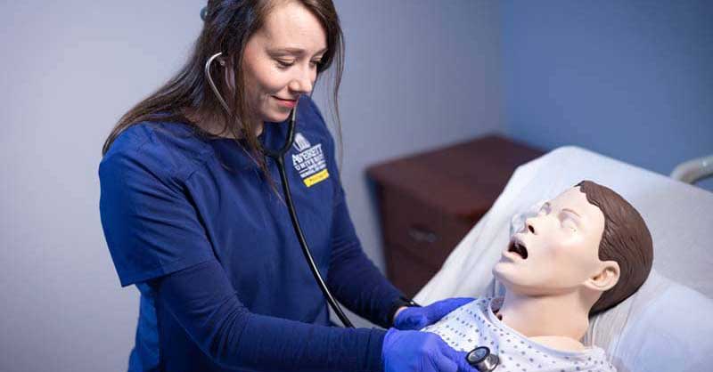 Averett nursing student working with sim manikin