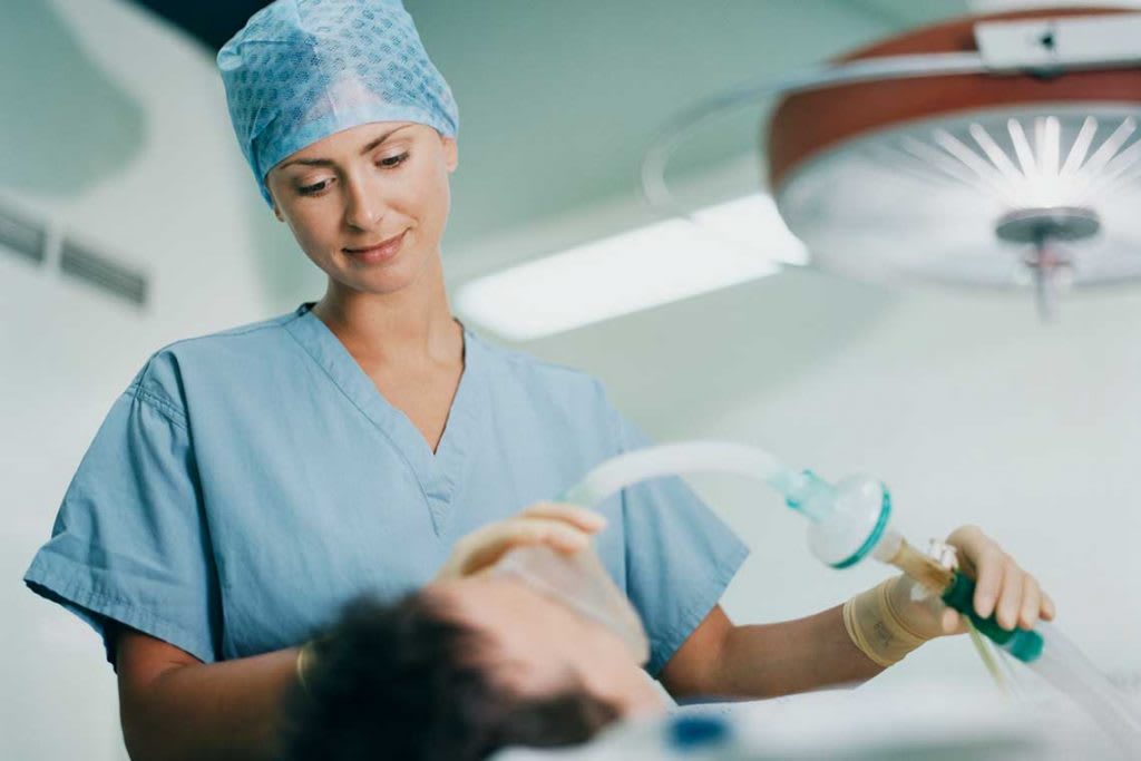 nurse giving patient anesthesia