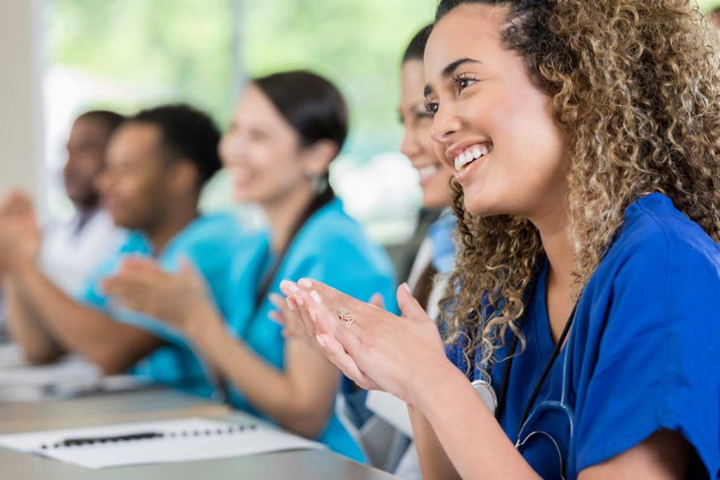 nursing students sitting at desk in classroom