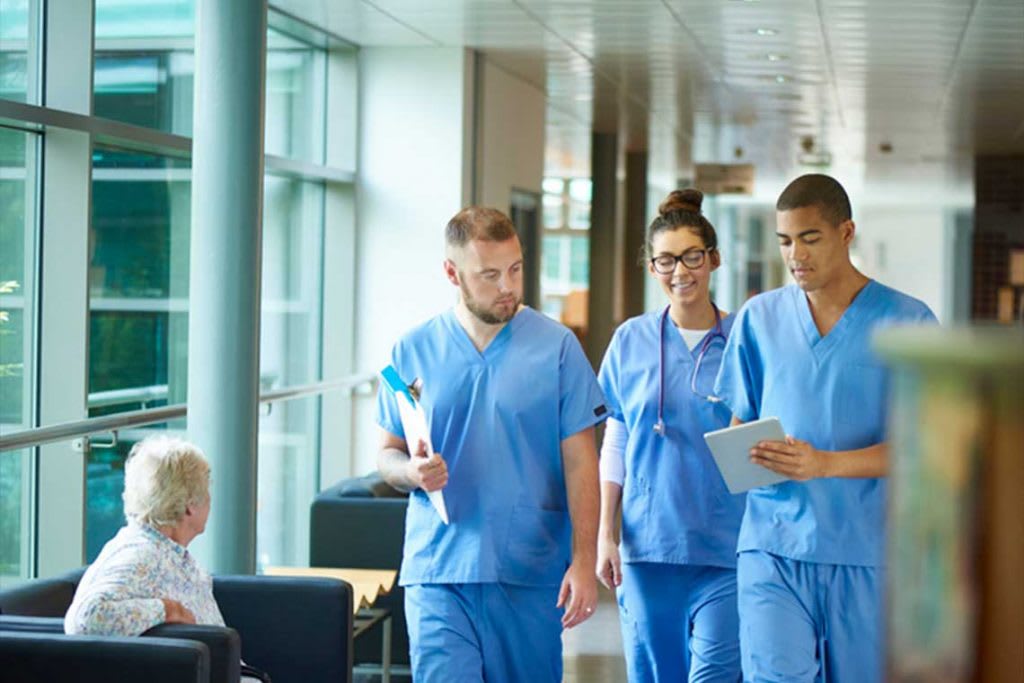 nurses walking together in hallway