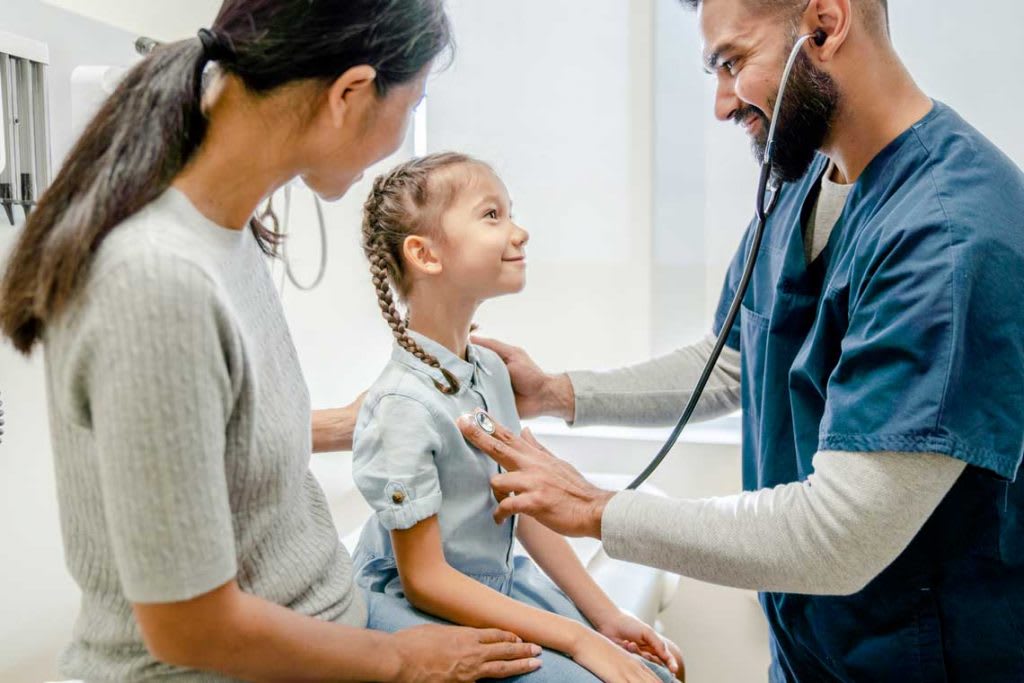 nurse practitioner with child patient and mother