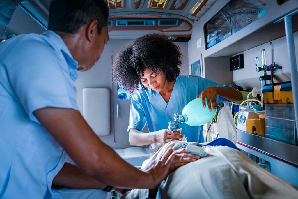 paramedics with patient in ambulence