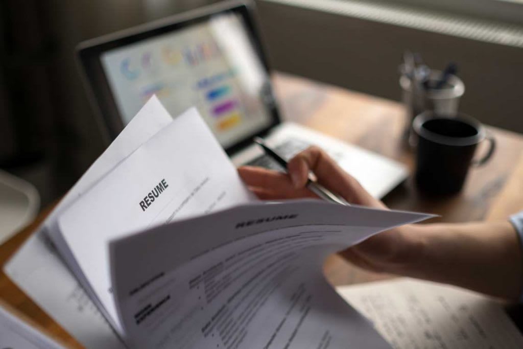 close up of person looking at resumes