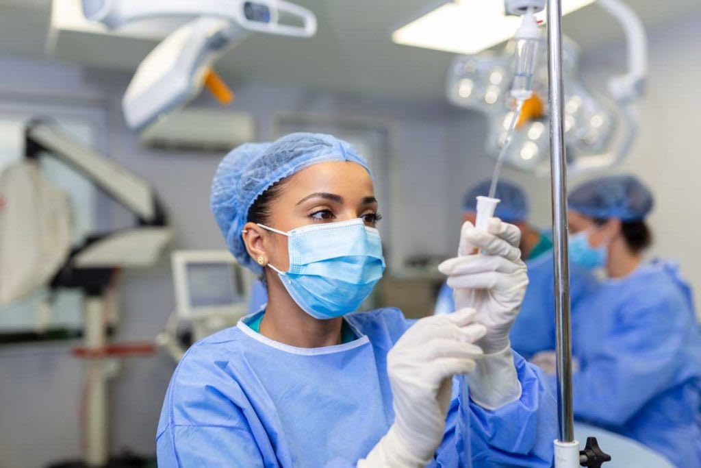 nurse with mask on fixing IV